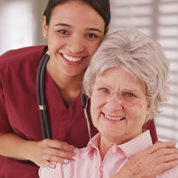 hispanic nurse with elderly woman