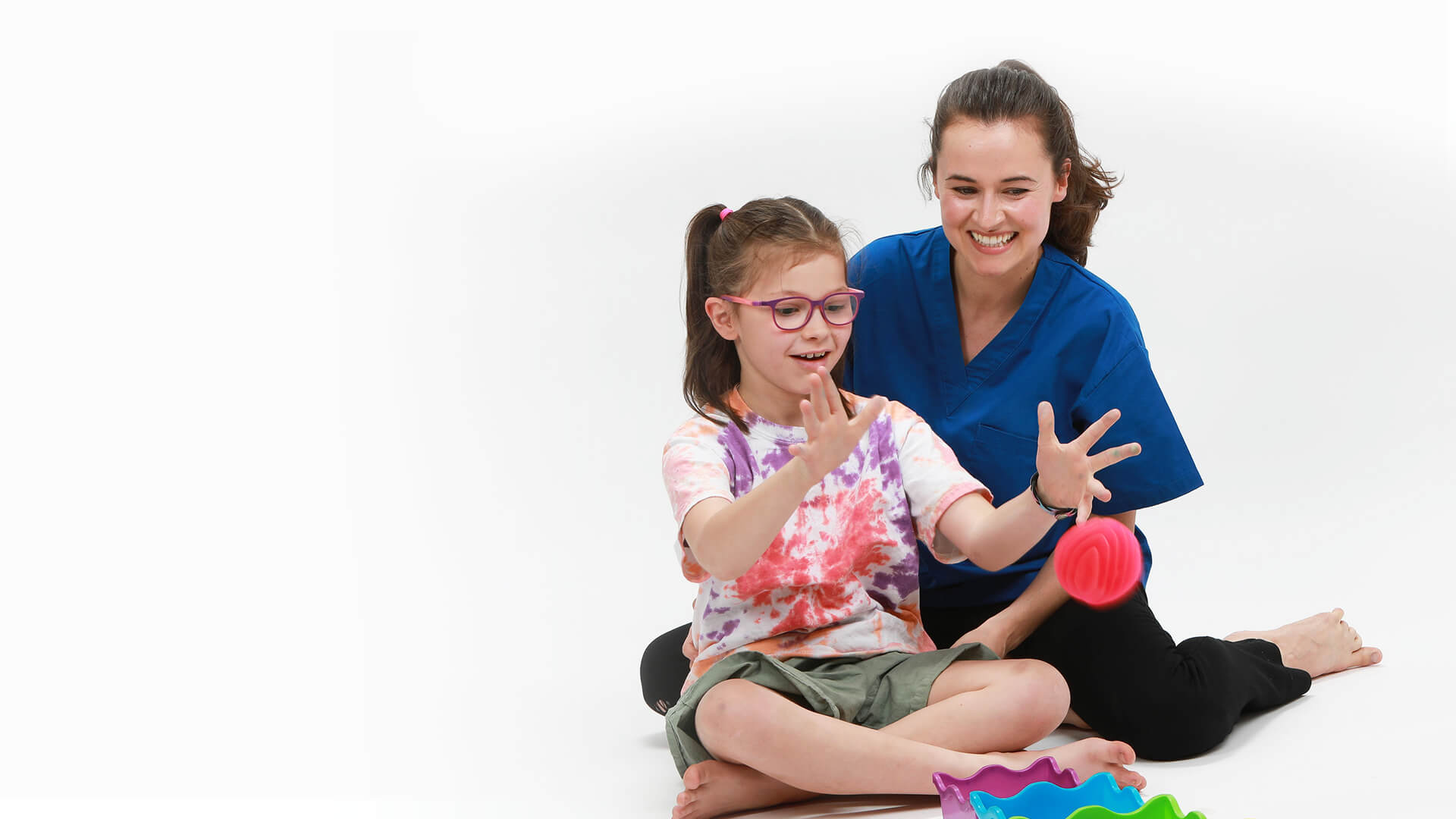 caregiver-playing-watching-girl-throw-ball